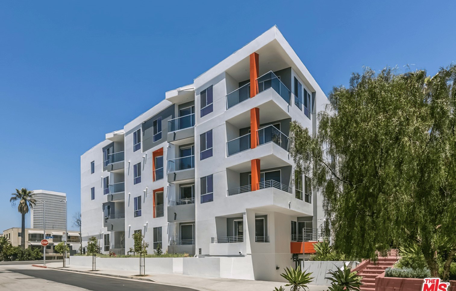 Exterior of Olympic Towers, a modern white apartment building with balconies