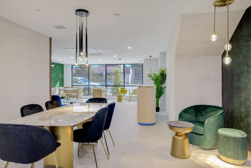 Communal dining table and lounge seating in The Felix on Fairfax lobby